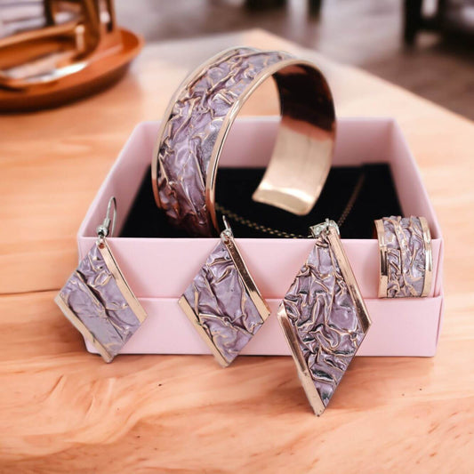 Front view of four-piece pink wrinkled copper jewellery set