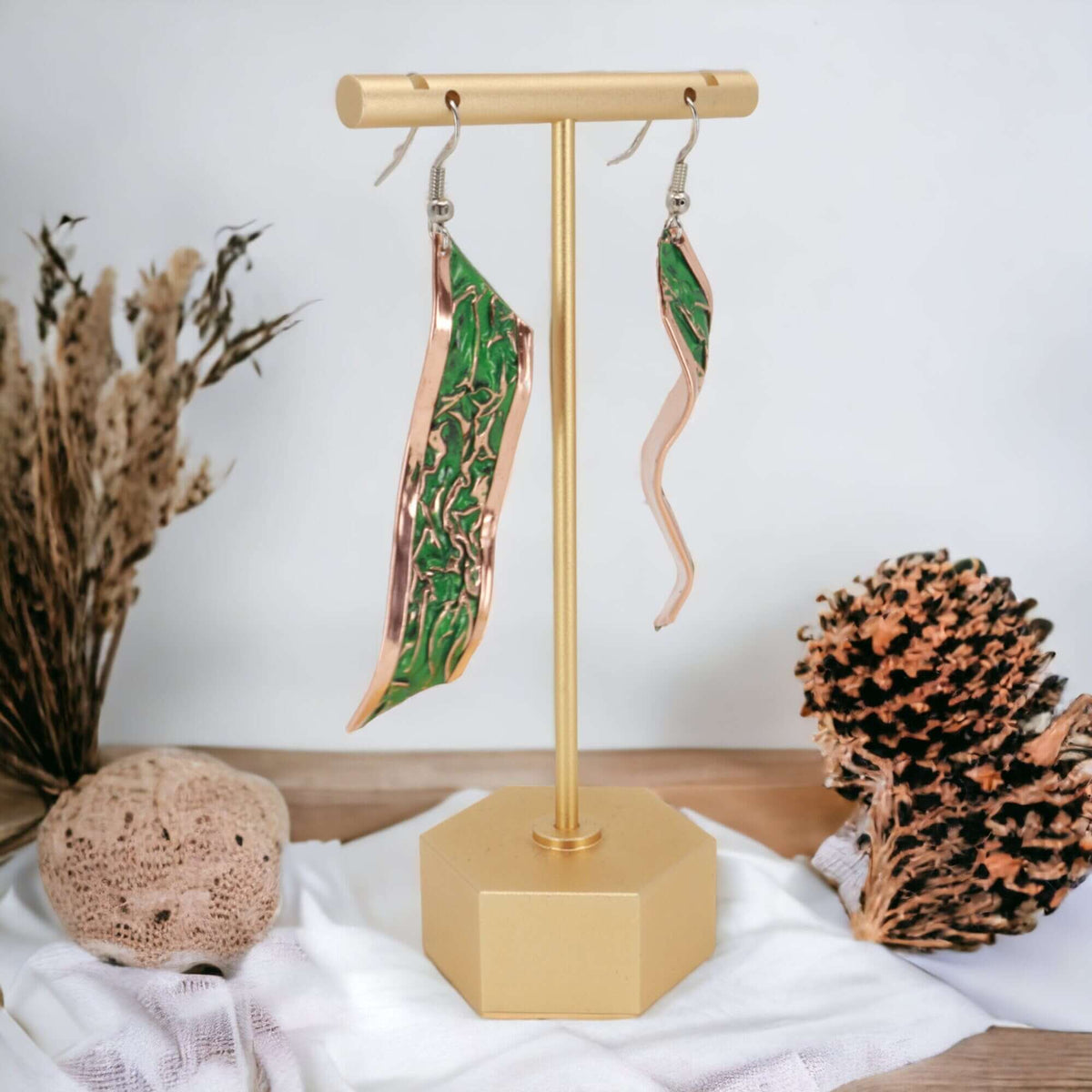 Front view of handcrafted artisan green wrinkled copper earrings