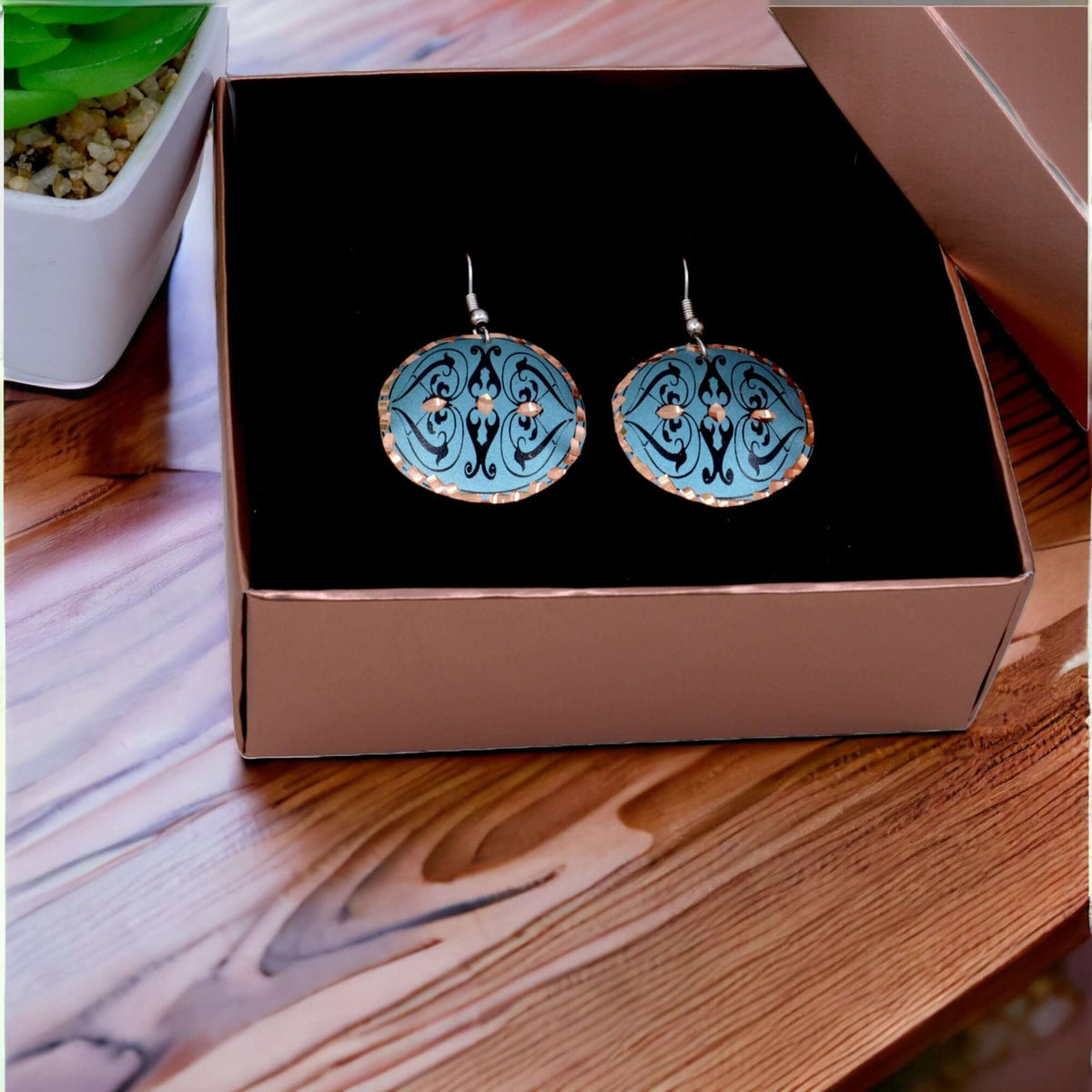 Front view of handcrafted artisan green copper circle earrings