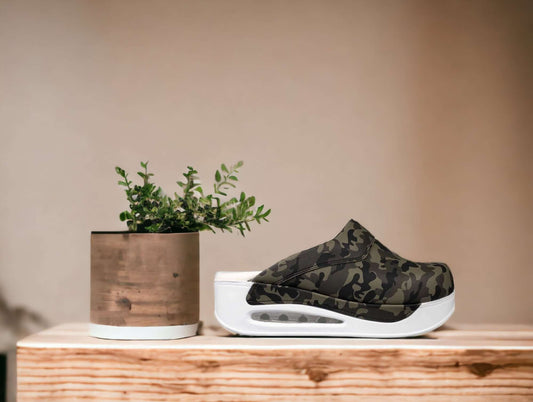 Front view of camouflage leather clogs with a white Air Clogx sole