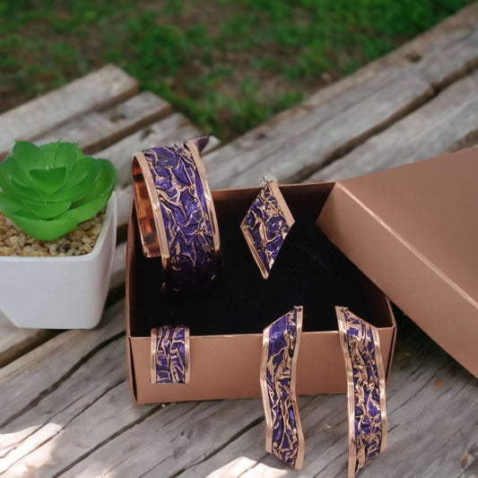 The full four-piece purple wrinkled copper jewellery set laid flat