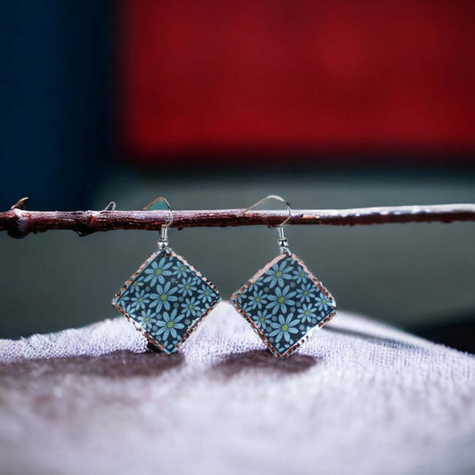 Front view of artisan turquoise flower copper square earrings