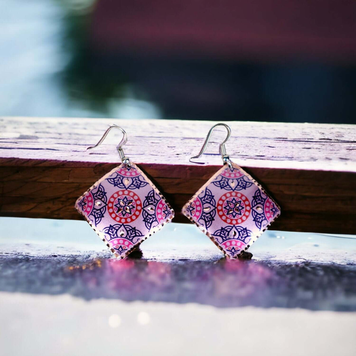 Handcrafted artisan pink copper square earrings worn on the ear