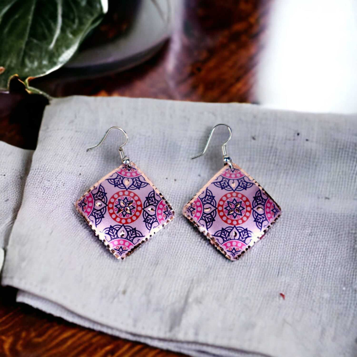 Front view of handcrafted artisan pink copper square earrings