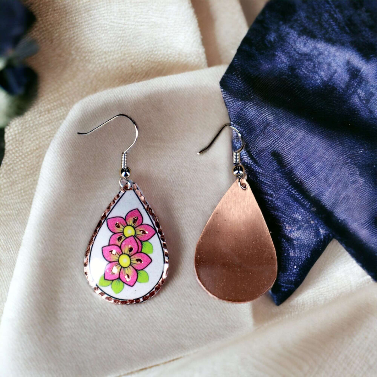Handcrafted pink flower copper drop earrings worn on the ear