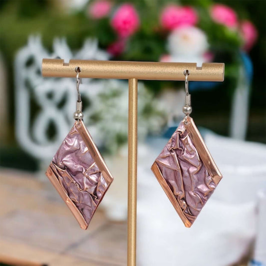 Front view of handcrafted artisan wrinkled copper earrings