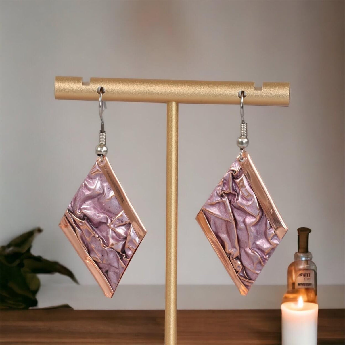 Side angle of handcrafted artisan wrinkled copper earrings