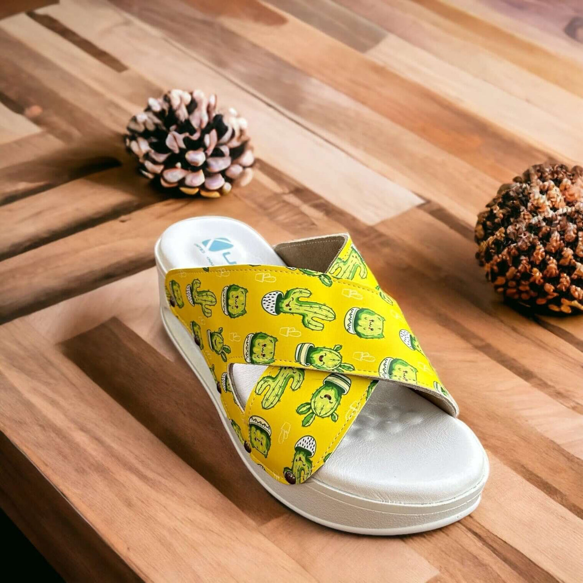 Top-down view of cactus print cross band leather clog slippers with an Air Clogx sole