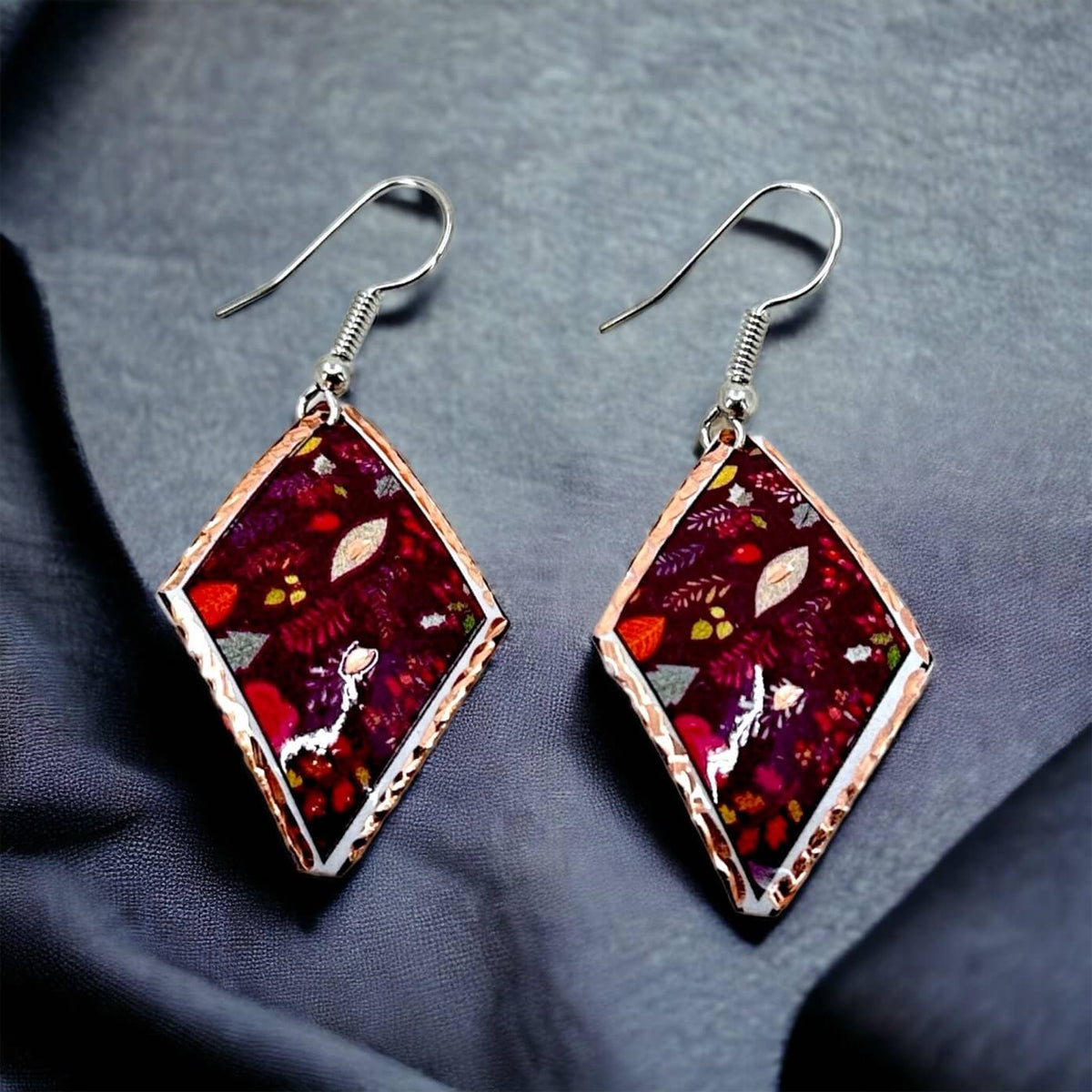 Earrings from the purple flowers copper jewellery set worn on the ear