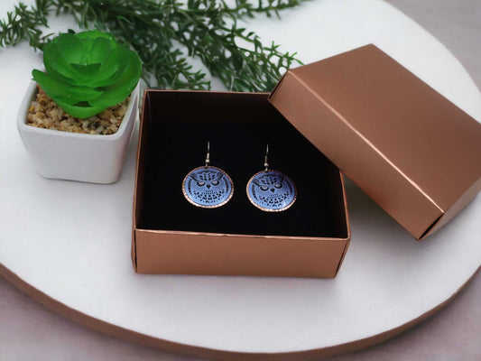 Front view of handcrafted blue owl copper circle earrings