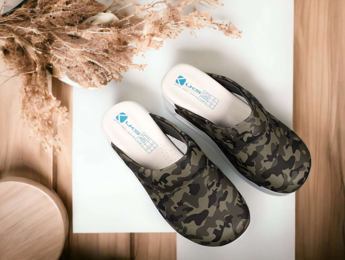 Camouflage leather clogs with a white Air Clogx sole worn on the foot
