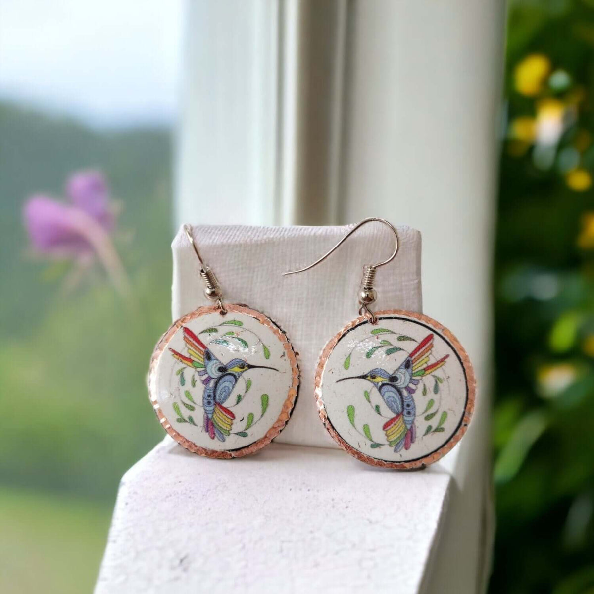 Side angle of handcrafted hummingbird copper circle earrings