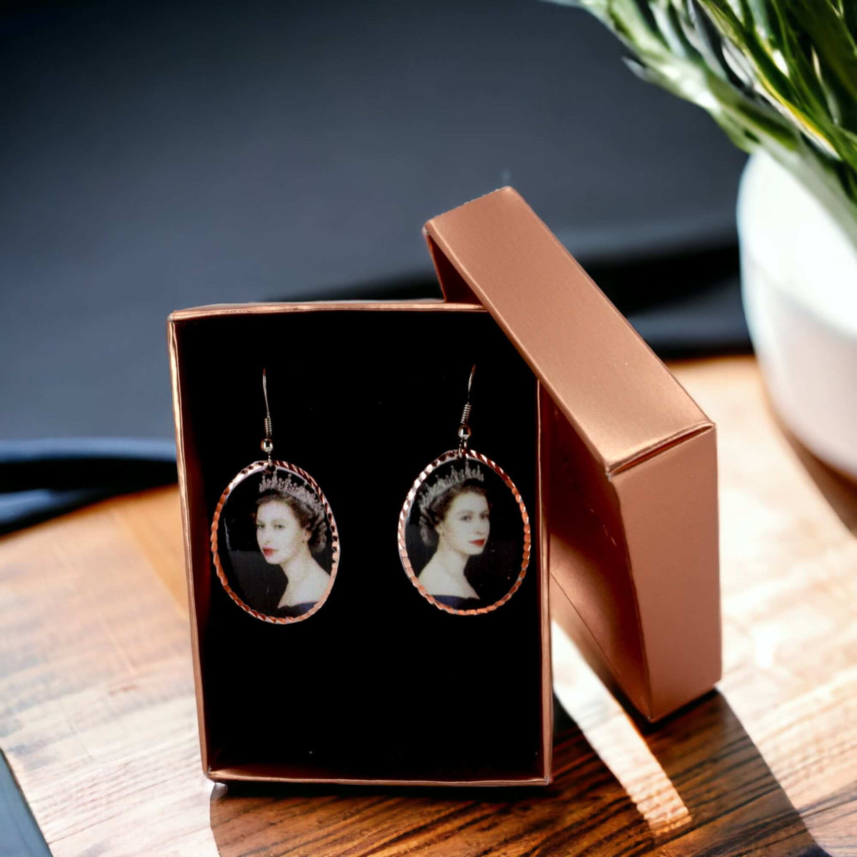 Artisan Queen Elizabeth II copper oval earrings worn on the ear