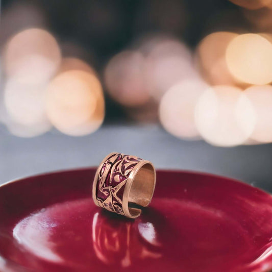 Front view of handmade magenta wrinkled copper adjustable ring