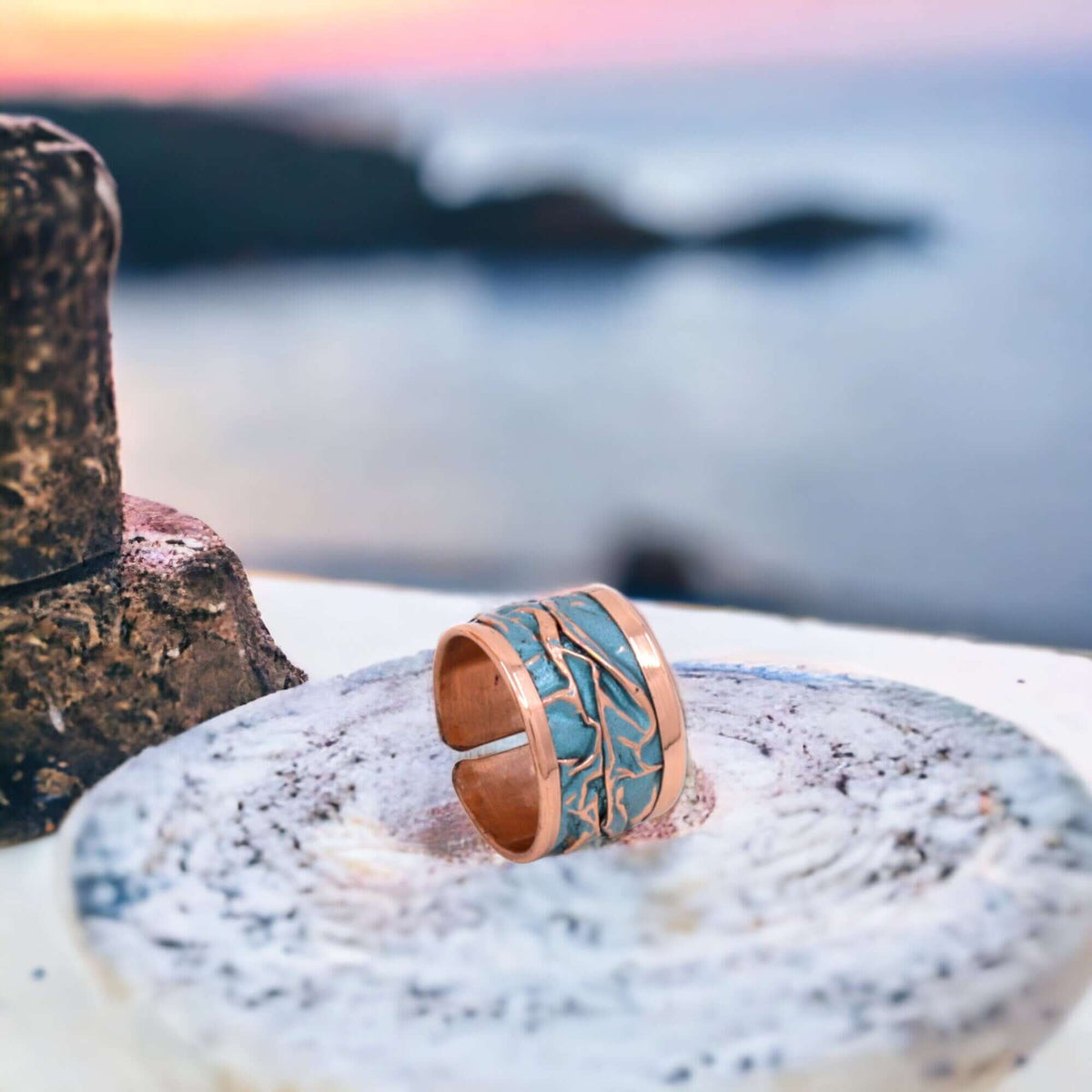 Turquoise wrinkled copper adjustable ring worn on the finger