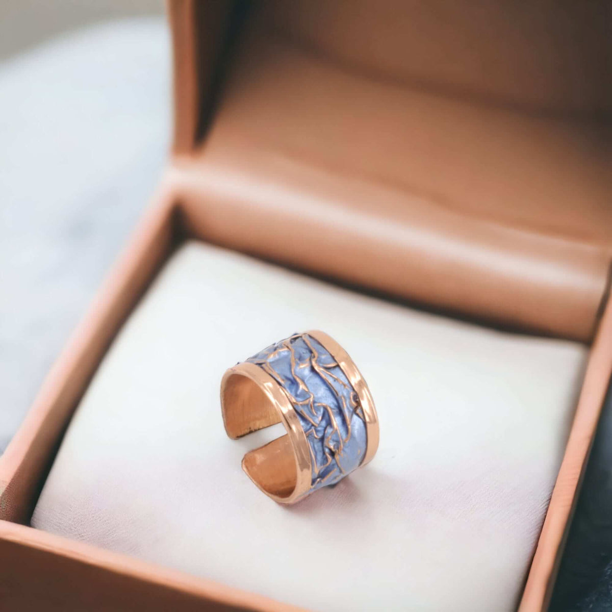 Close-up of the copper texture on handmade blue wrinkled copper adjustable ring