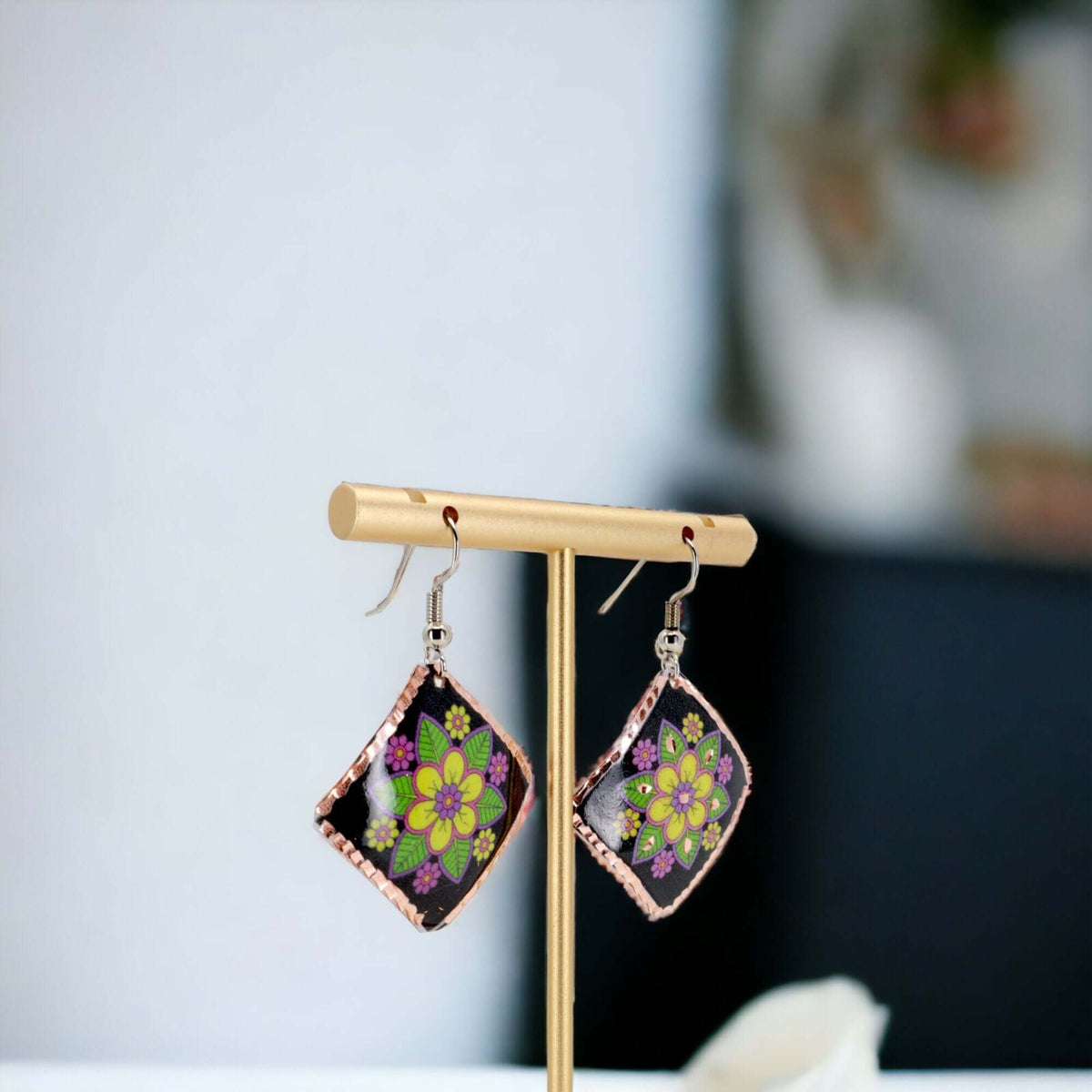 Side angle of handcrafted square yellow flower copper earrings