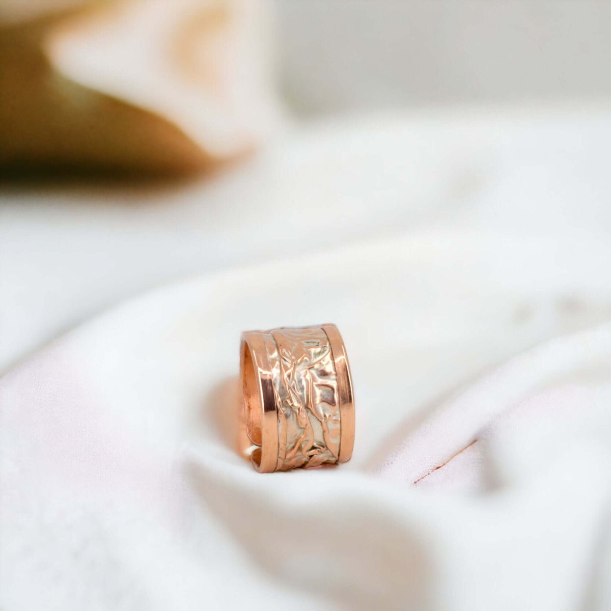 Top-down view of artisan silver wrinkled copper adjustable ring