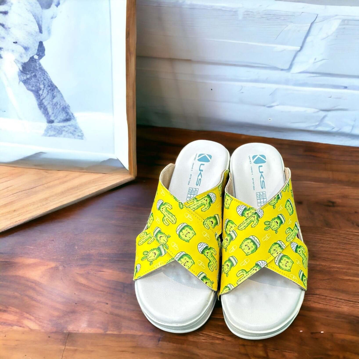 Strap and buckle detail on cactus print cross band leather clog slippers with an Air Clogx sole