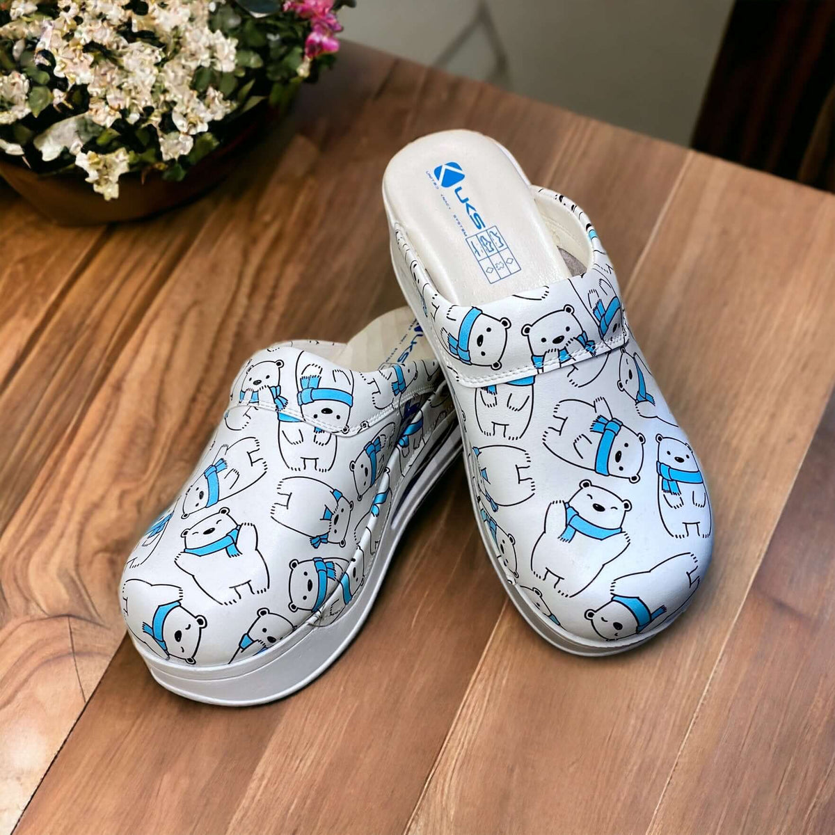 Front view of handmade polar bear design leather clogs with an Air Clogx sole