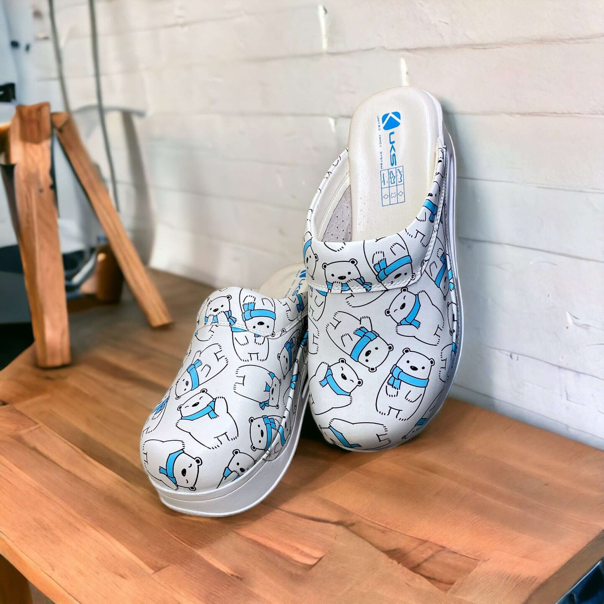 Side profile of handmade polar bear design leather clogs with an Air Clogx sole