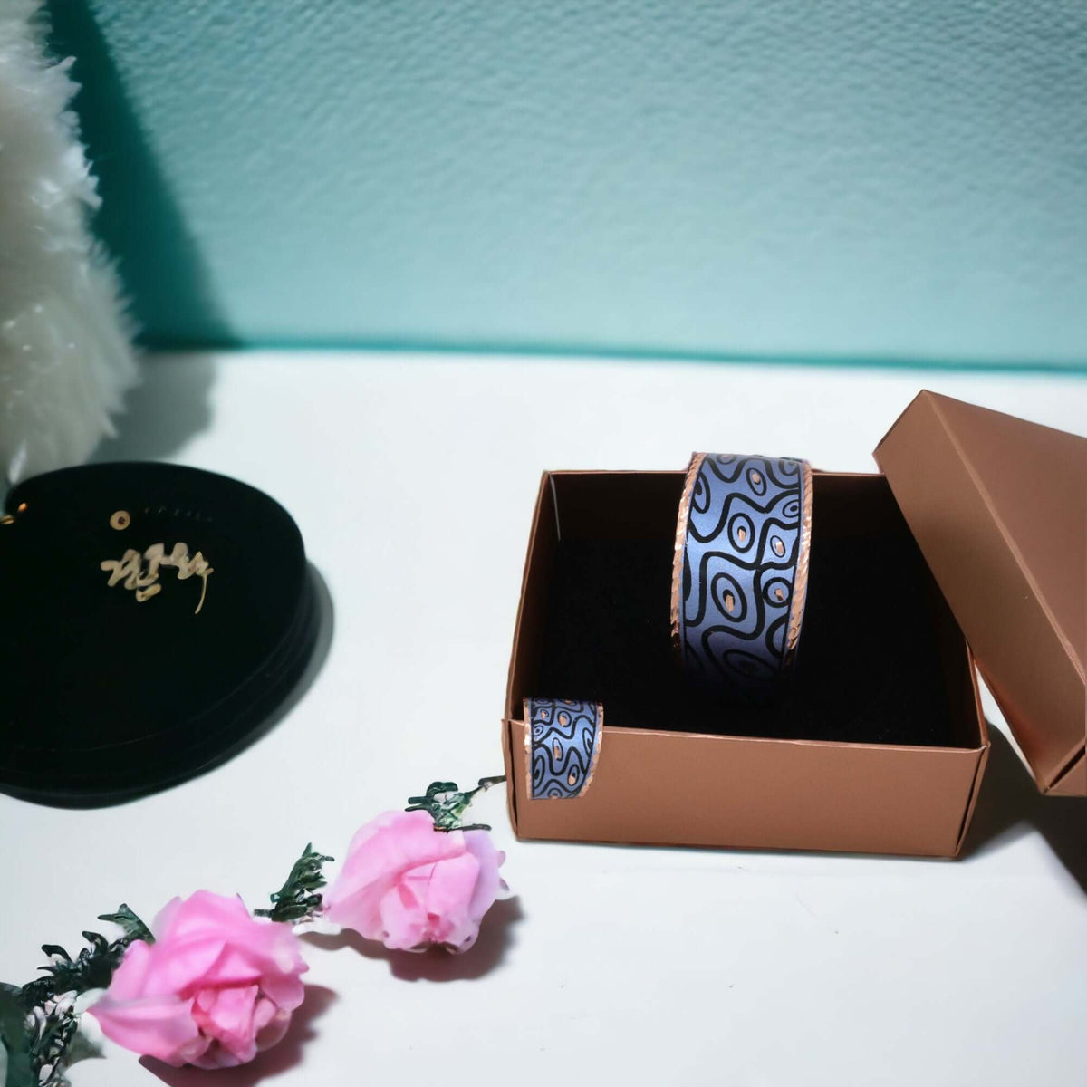 Close-up of the copper texture in handcrafted blue curvy copper statement jewellery set