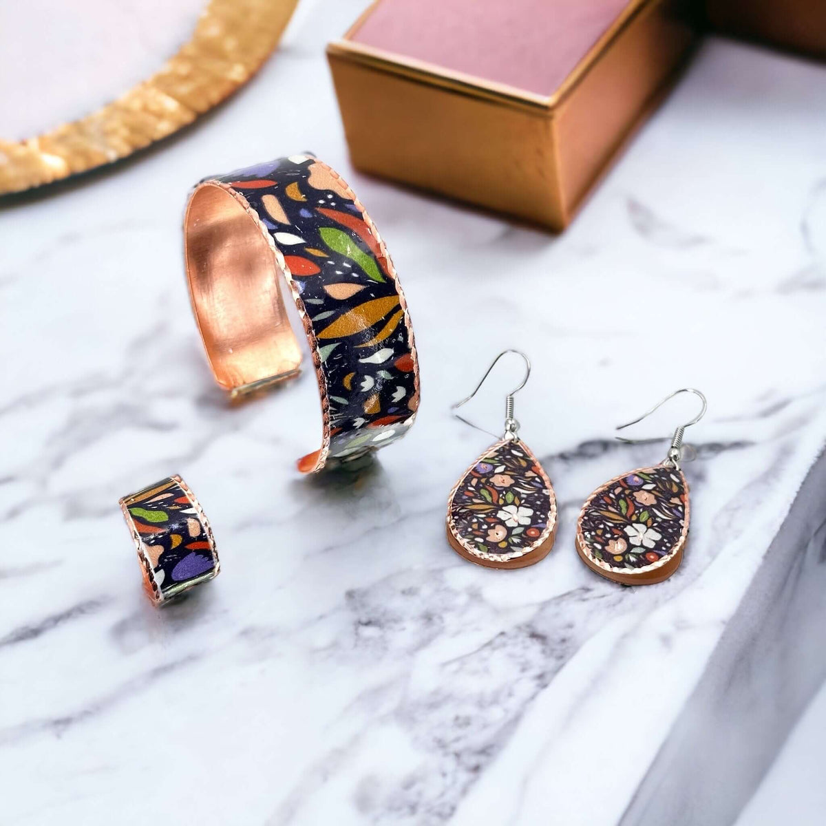 The full three-piece purple and white flowers copper jewellery set laid flat