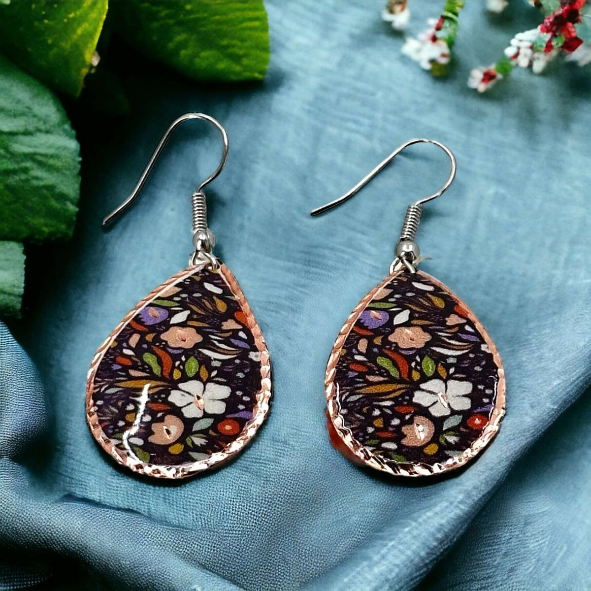 Side angle of three-piece purple and white flowers copper jewellery set
