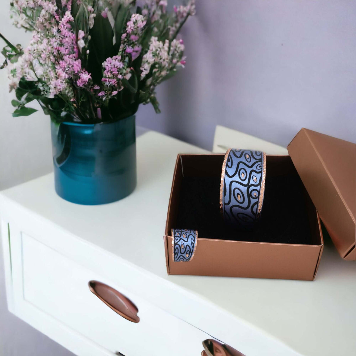 The full handcrafted blue curvy copper statement jewellery set laid flat