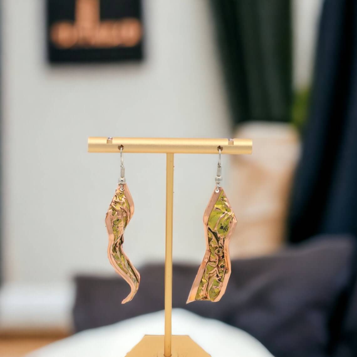 Four-piece yellow wrinkled copper jewellery set shown next to a hand for scale