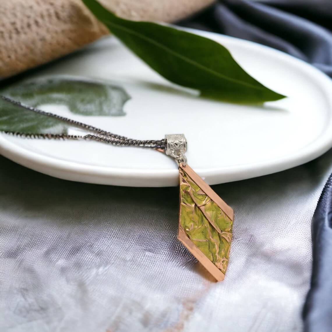 Top-down view of four-piece yellow wrinkled copper jewellery set