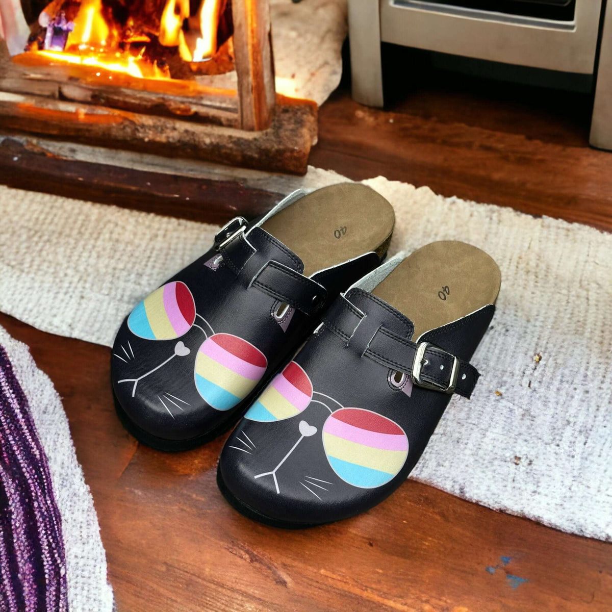 A pair of orthopedic cat glasses leather clogs with a cork sole placed side by side